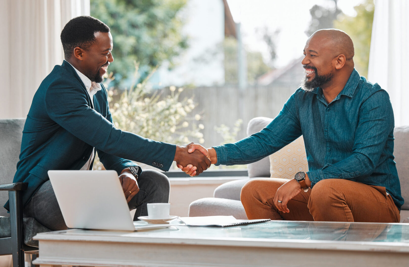 Two men shaking hands in a friendly business meeting.