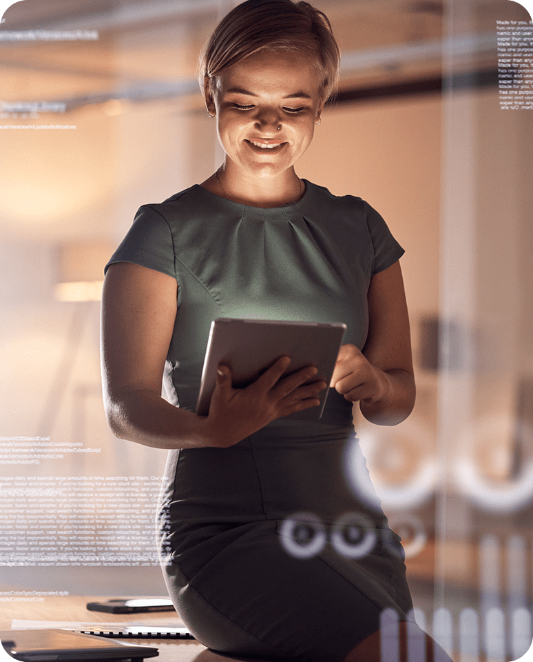 Woman smiling while using a tablet in a modern office setting.